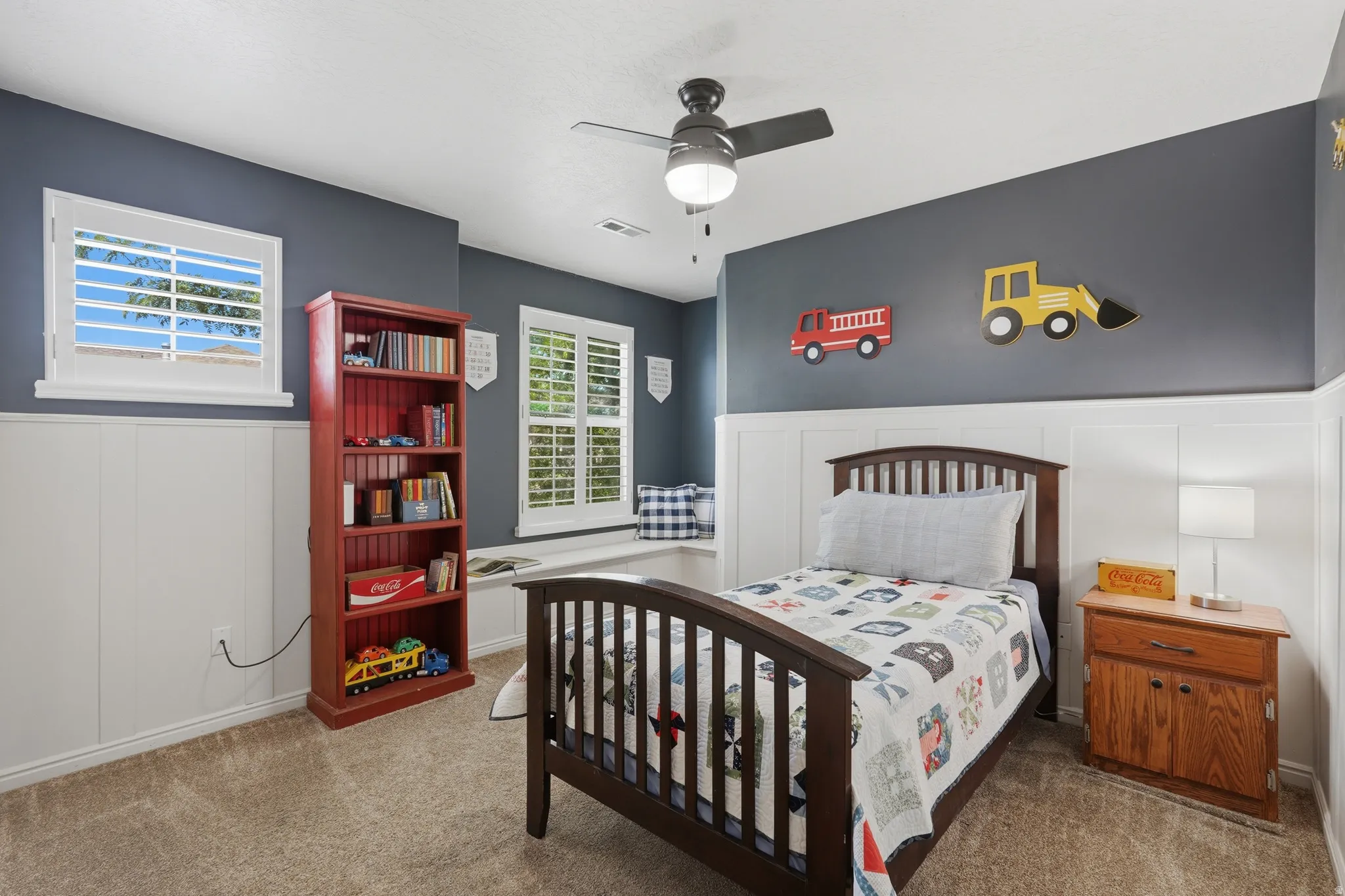 Neutral wall colors with wainscoting and carpeted flooring