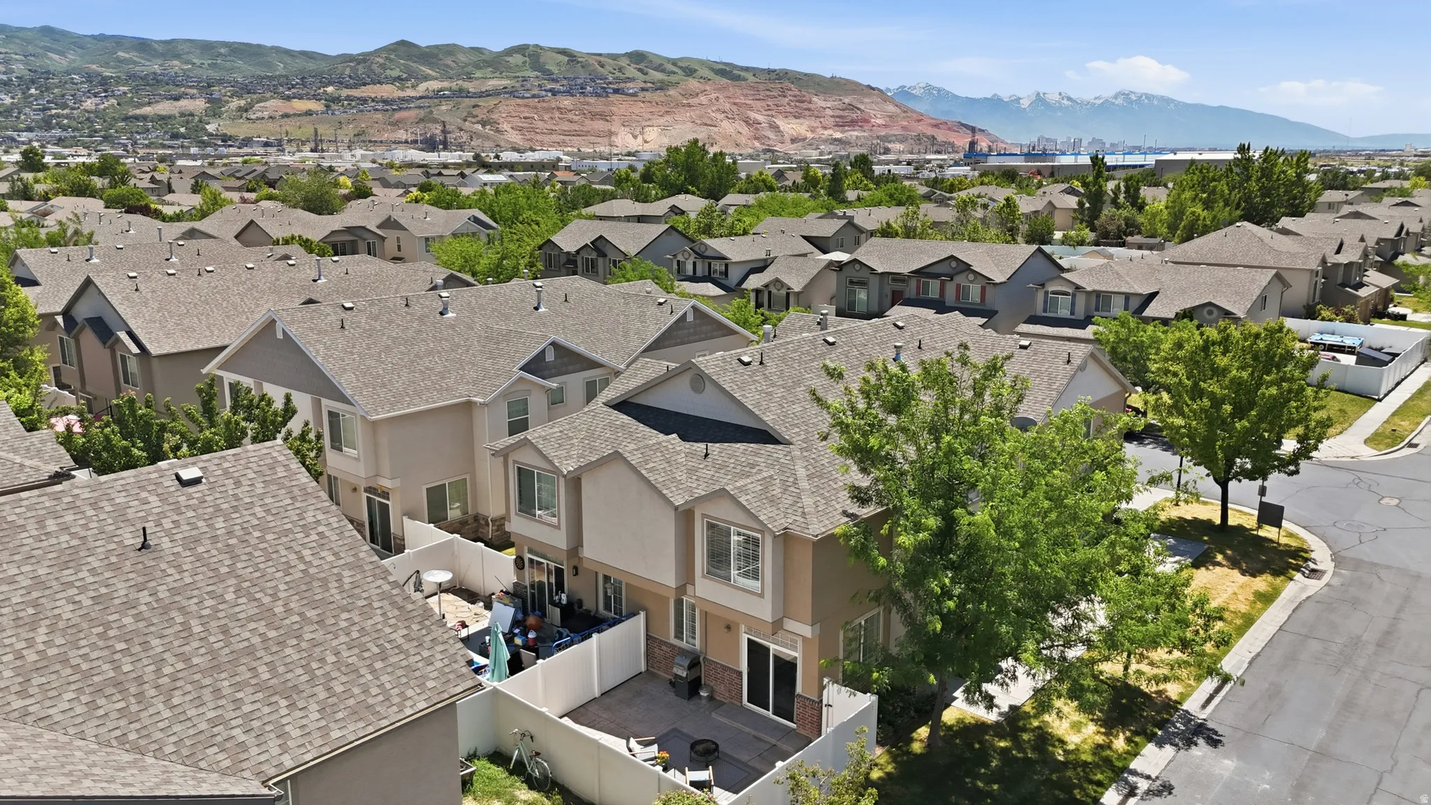Townhome community featuring neutral-toned exteriors and asphalt shingle roofs