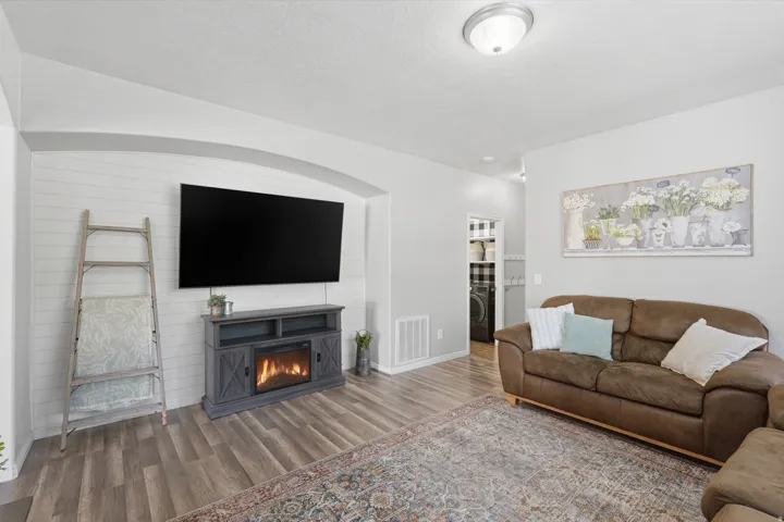 Living area featuring wood-finish flooring and light gray walls