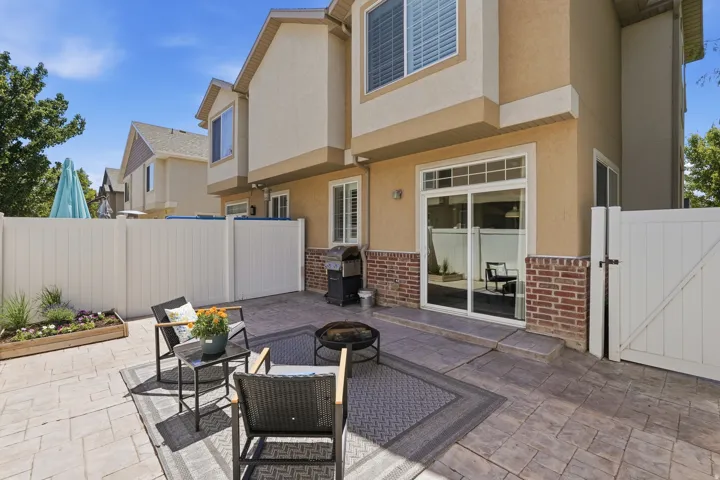 Private outdoor patio space featuring stamped concrete flooring
