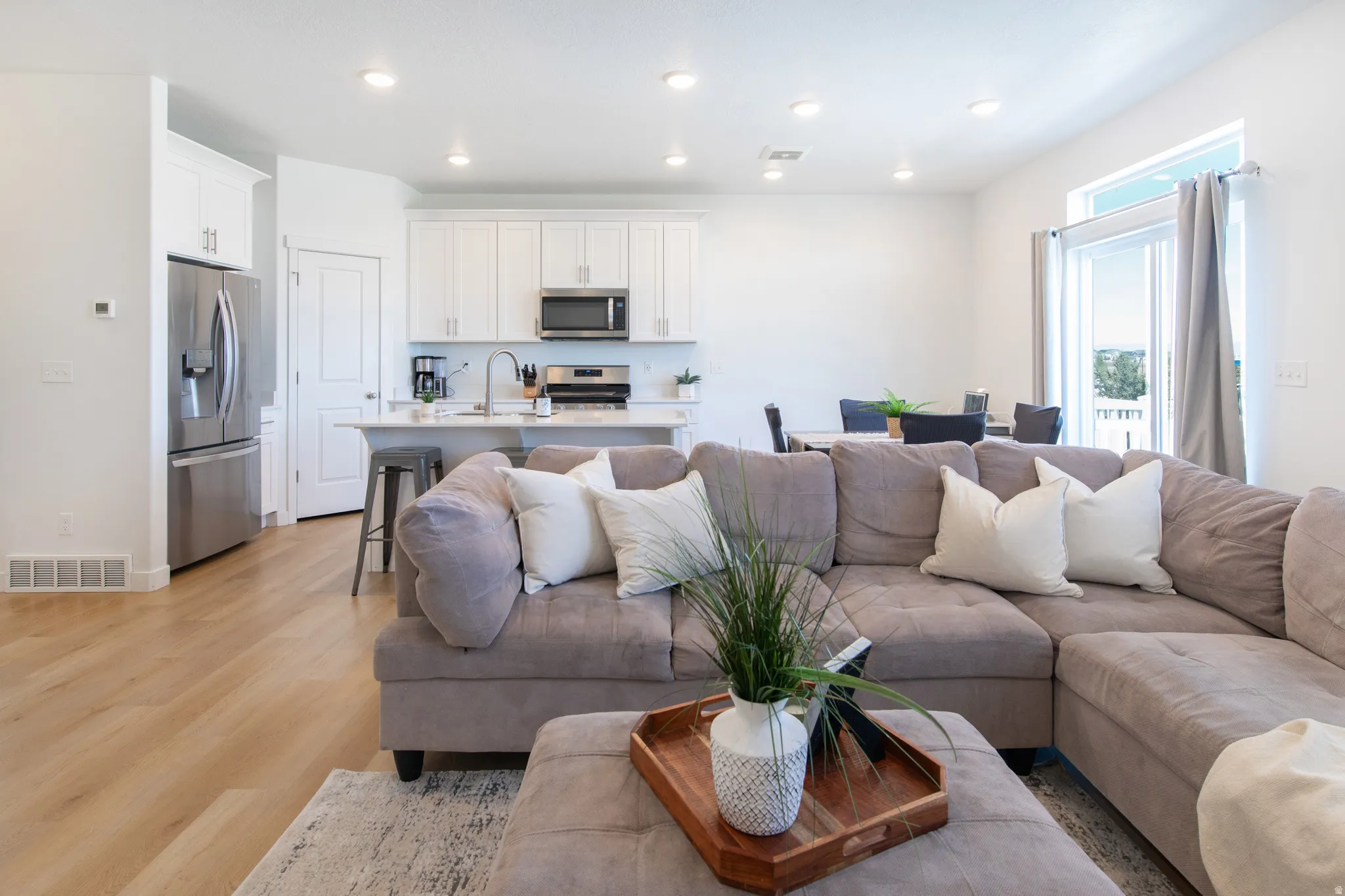 Open concept living area featuring light wood-finish flooring
