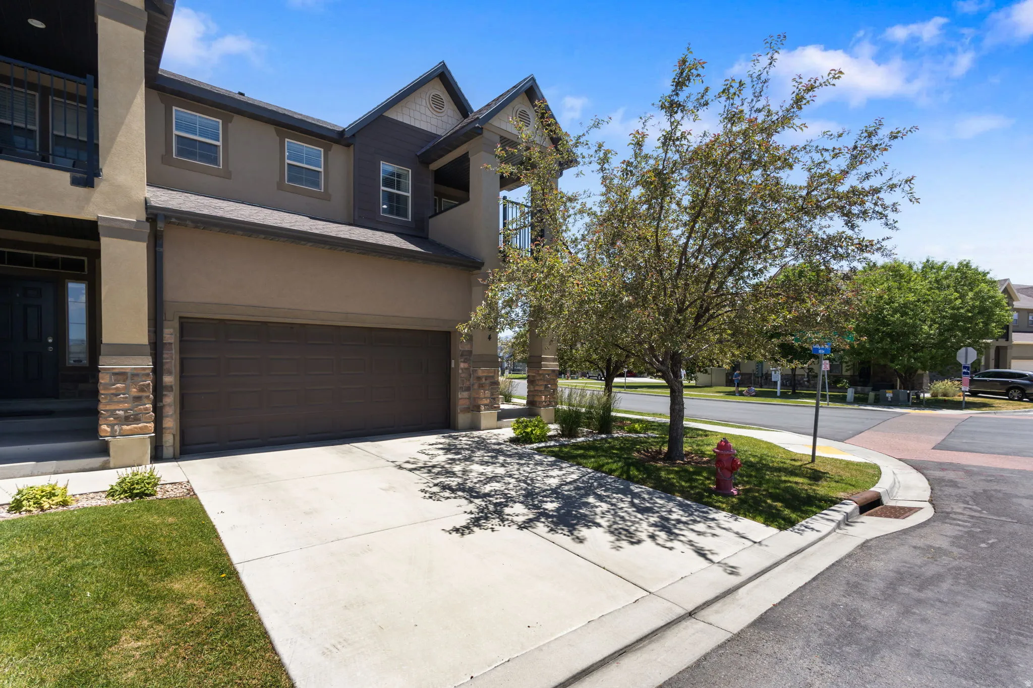 Contemporary stucco exterior with stone accents and a two-car garage