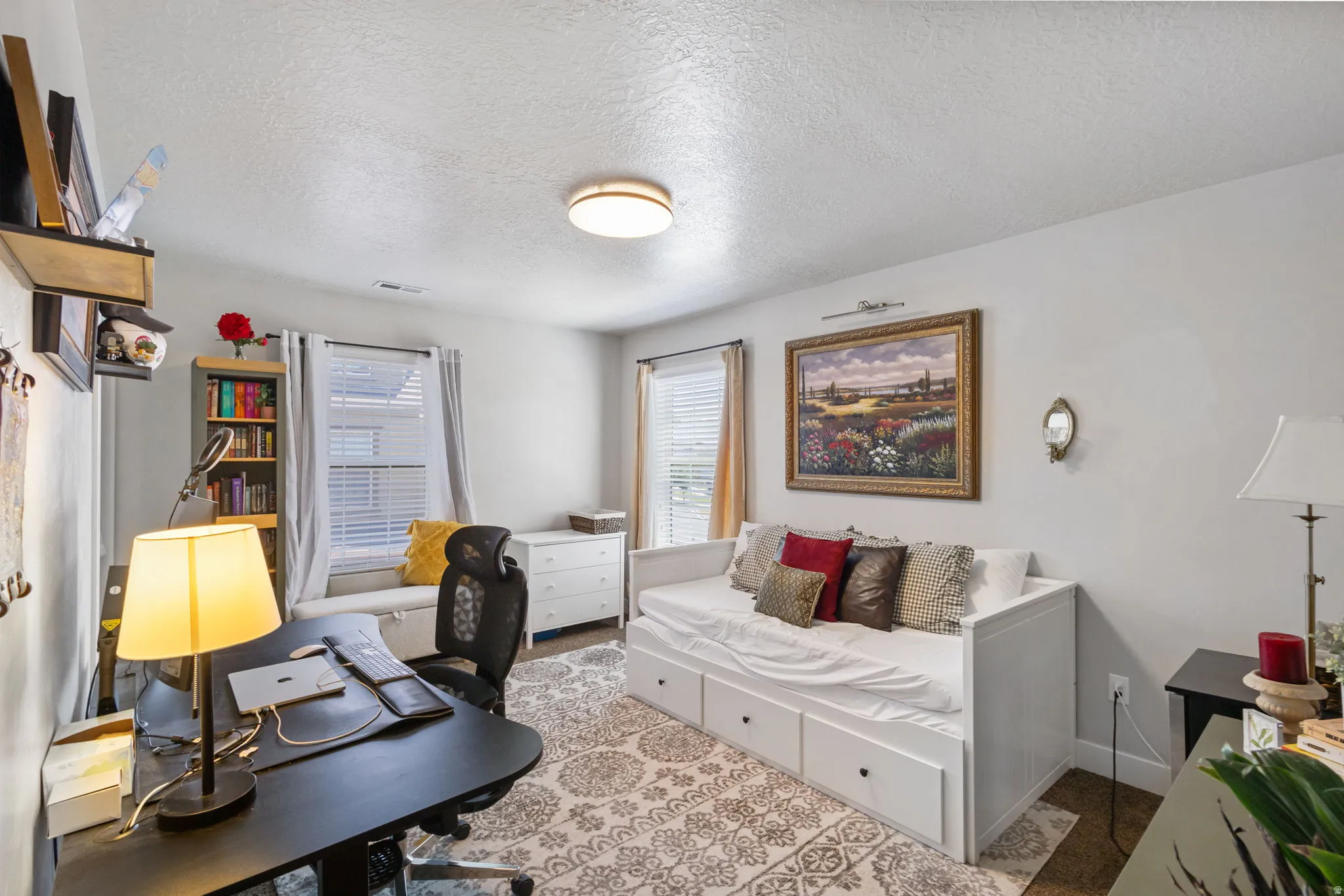 Bright interior space featuring multiple windows with blinds, a built-in window seat, and neutral wall tones