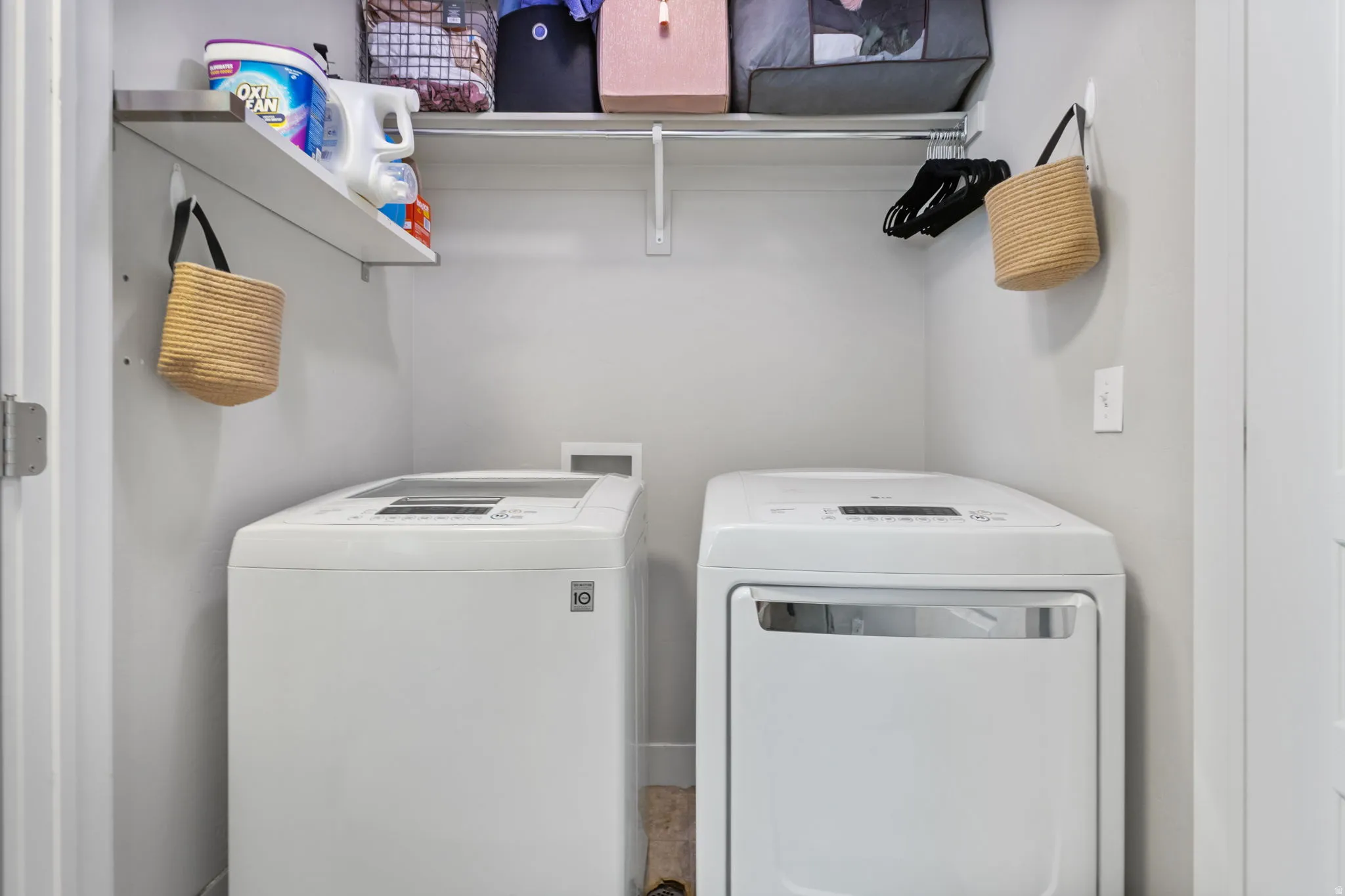 Dedicated laundry area featuring a top-load washing machine and front-load dryer