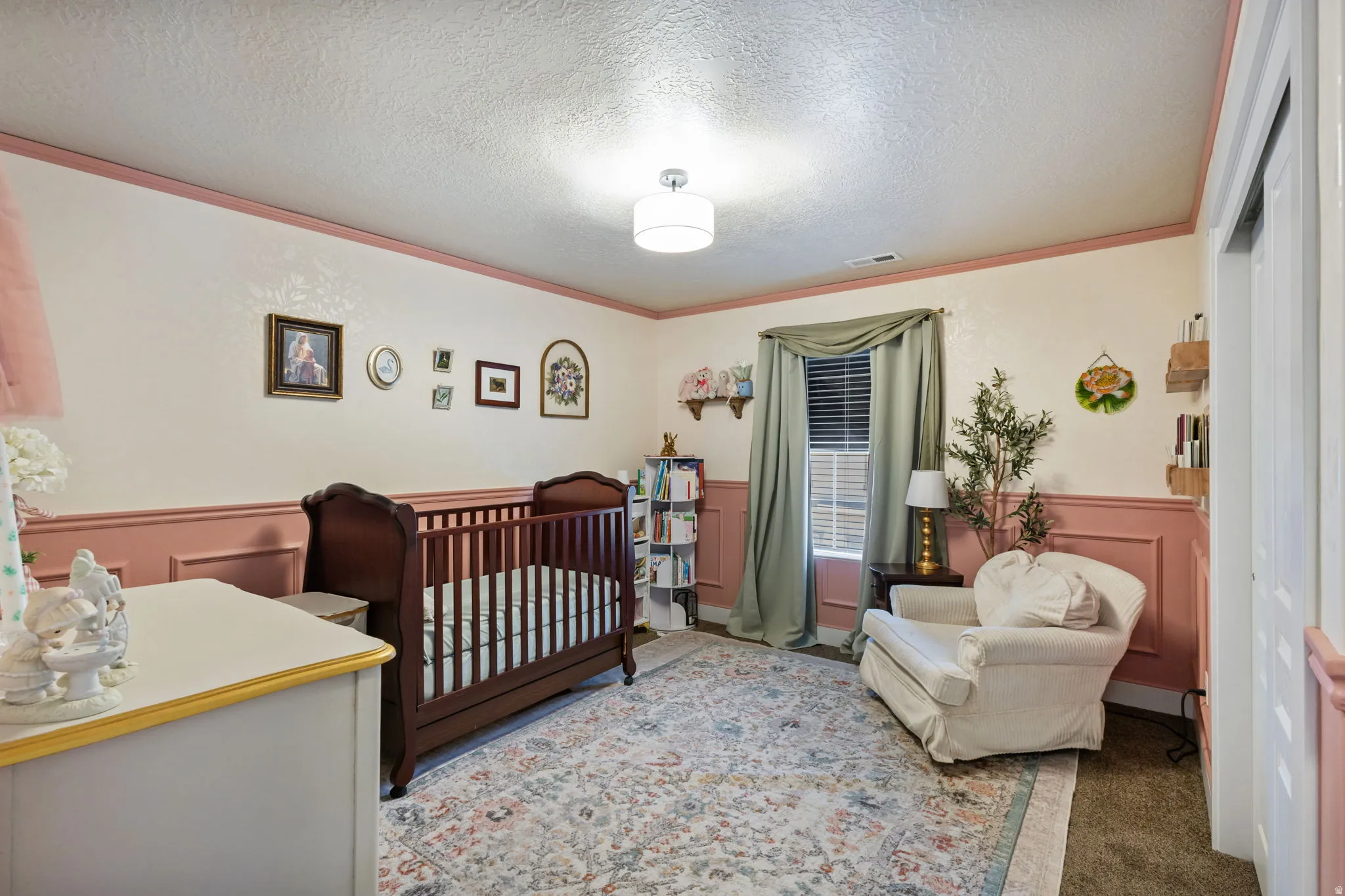 Textured ceiling and light-toned walls with lower paneling