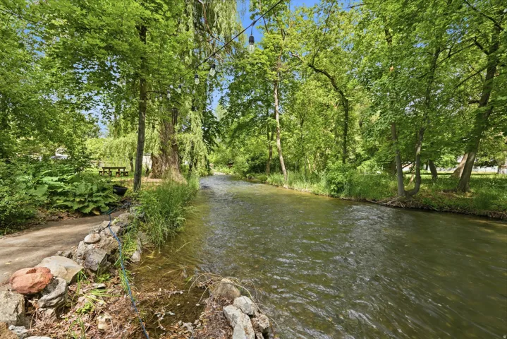 Property featuring a natural waterway bordered by extensive foliage
