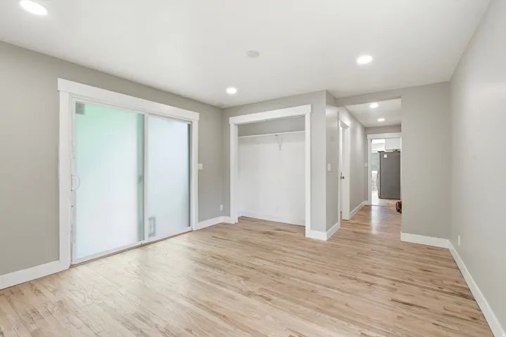 Light wood-finish flooring complements the light gray wall tones