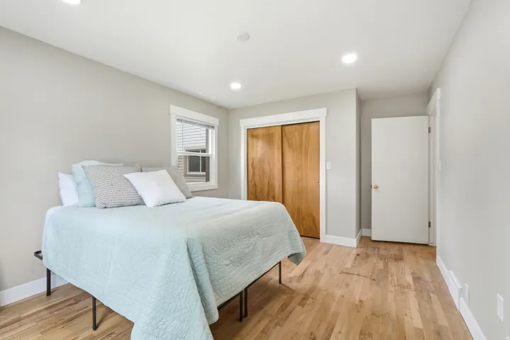 Room featuring wood-finish flooring, recessed lighting, and a window with blinds
