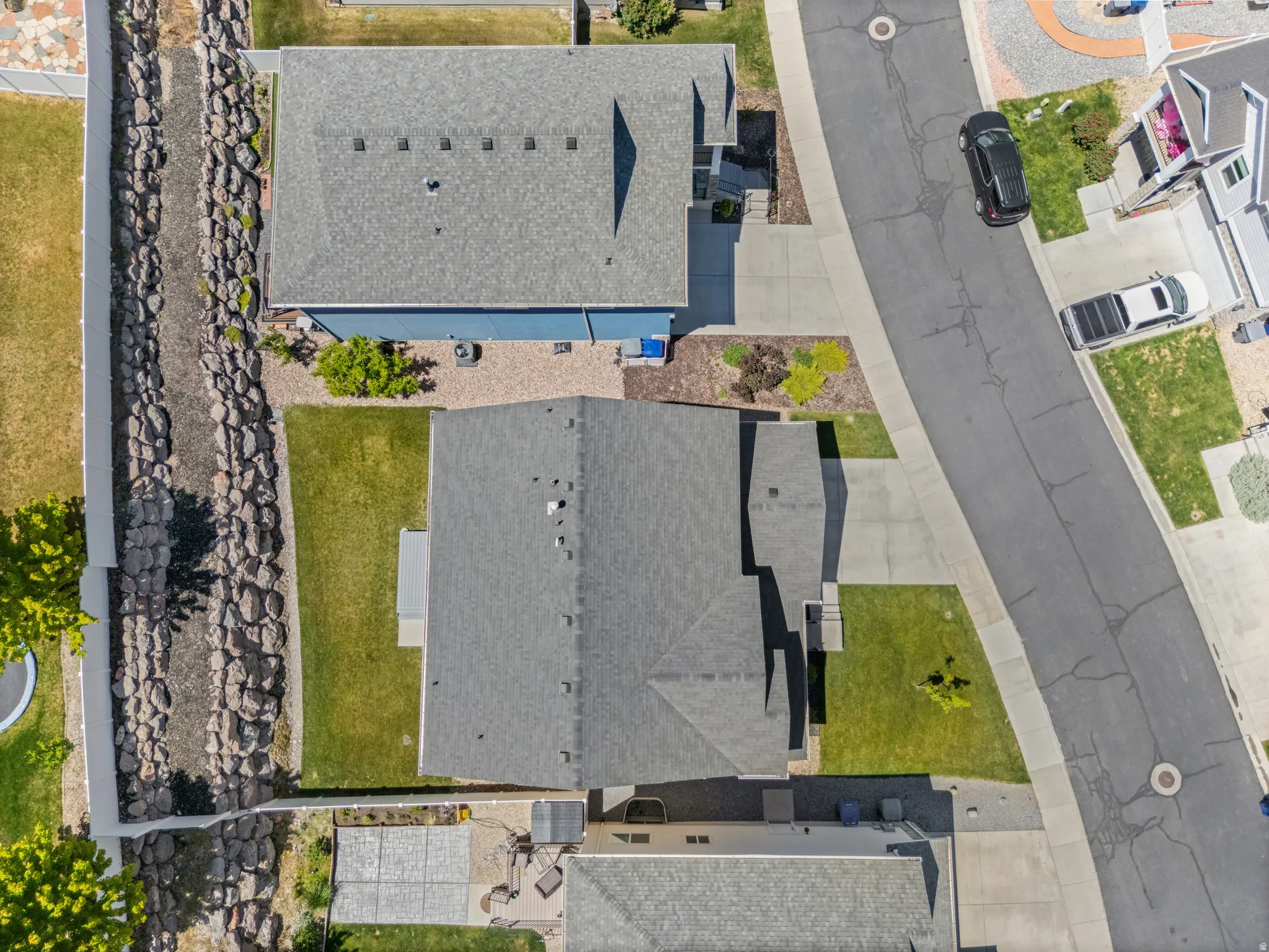 Aerial view of a residential property with a gray asphalt shingle roof