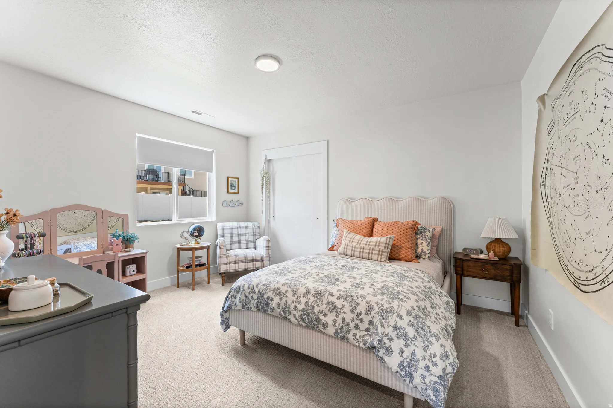 Spacious room featuring neutral carpeting, recessed lighting, and a window with blinds