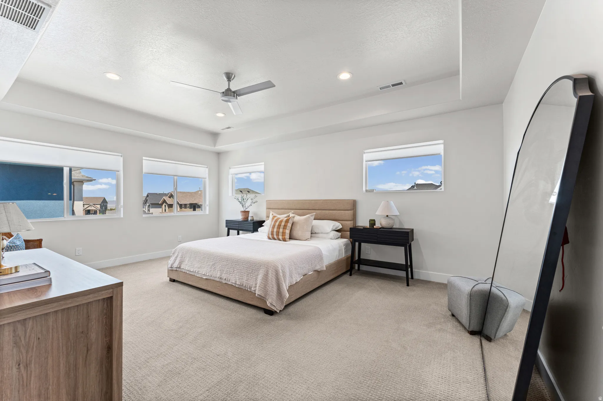 Spacious room featuring multiple windows, recessed lighting, and a ceiling fan