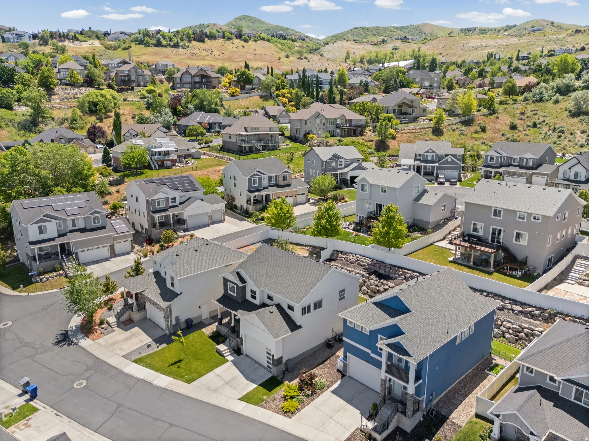Residential neighborhood featuring varied architectural styles and surrounding hillsides