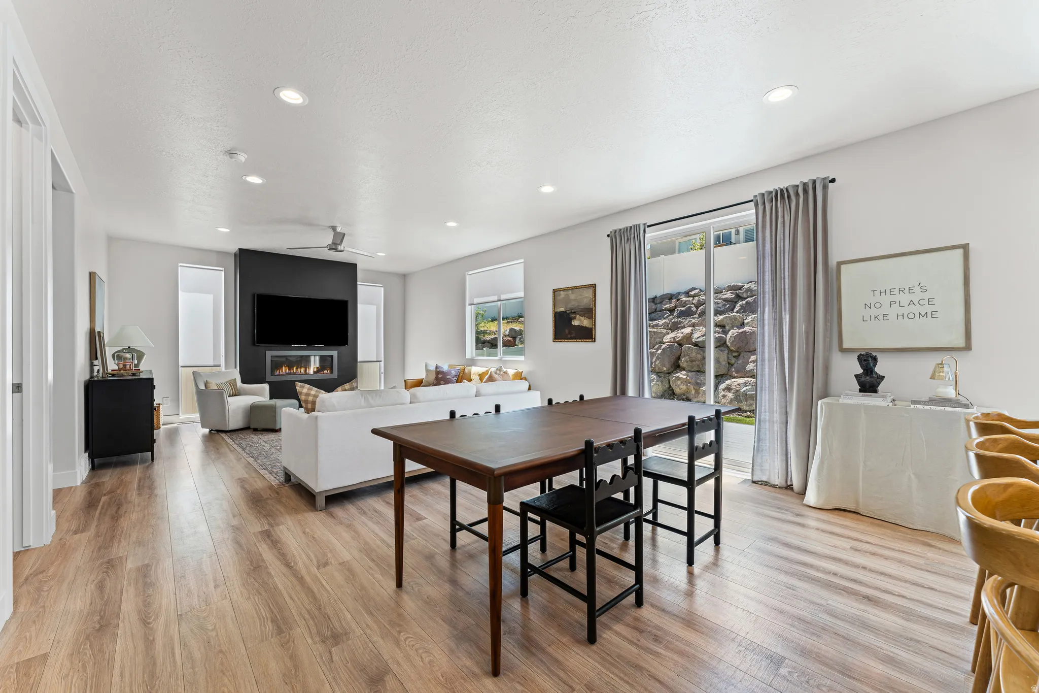 Open-concept living space featuring wood-finish flooring, recessed lighting, and a modern ceiling fan