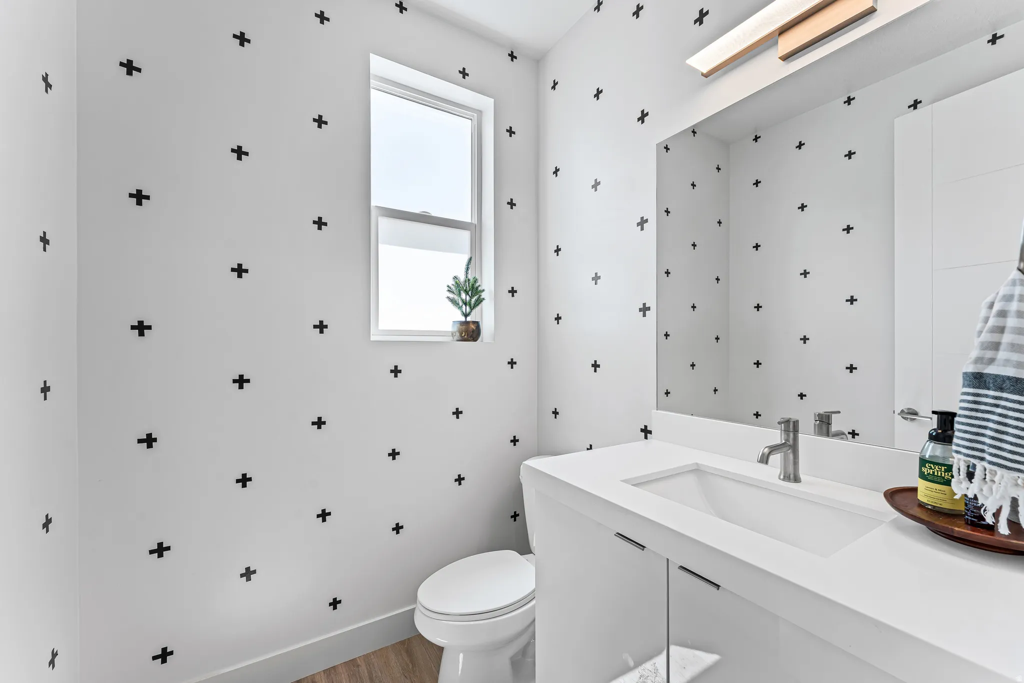 Contemporary vanity with an integrated rectangular sink, brushed nickel faucet, and under-cabinet storage