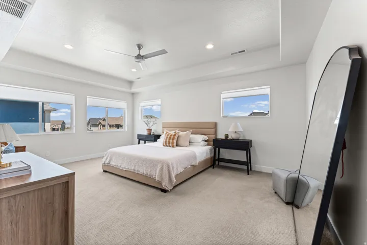 Spacious room featuring multiple windows, recessed lighting, and a ceiling fan
