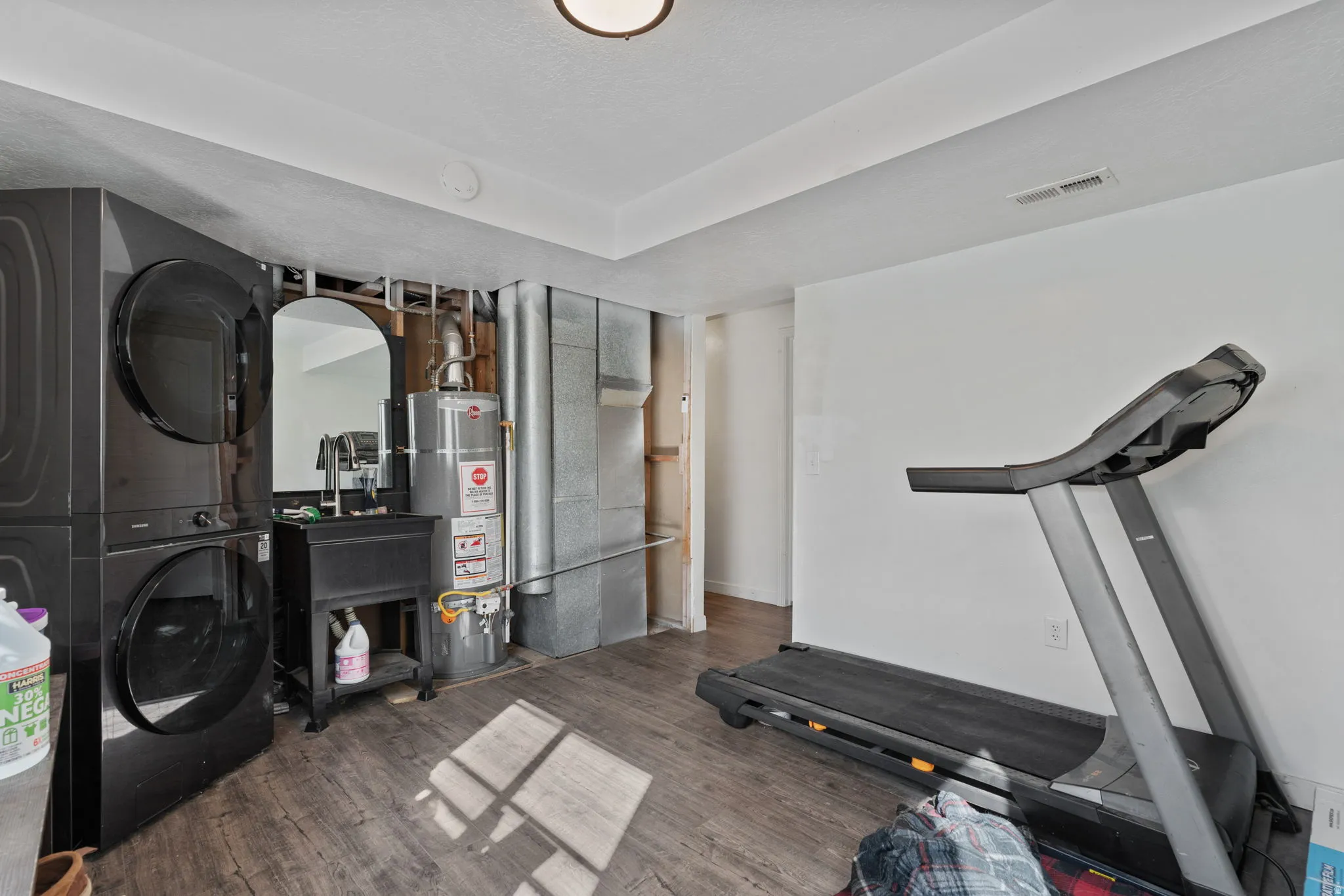 Utility space featuring wood-finish flooring and white walls