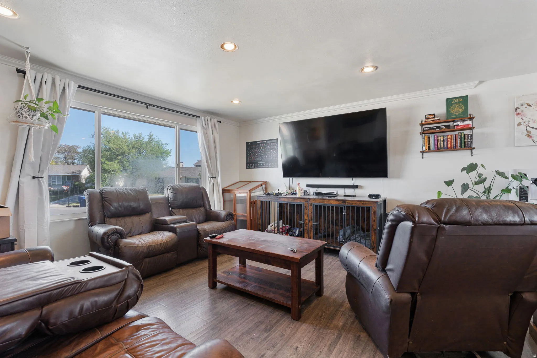 Living area featuring wood-finish flooring, recessed lighting, and a large picture window