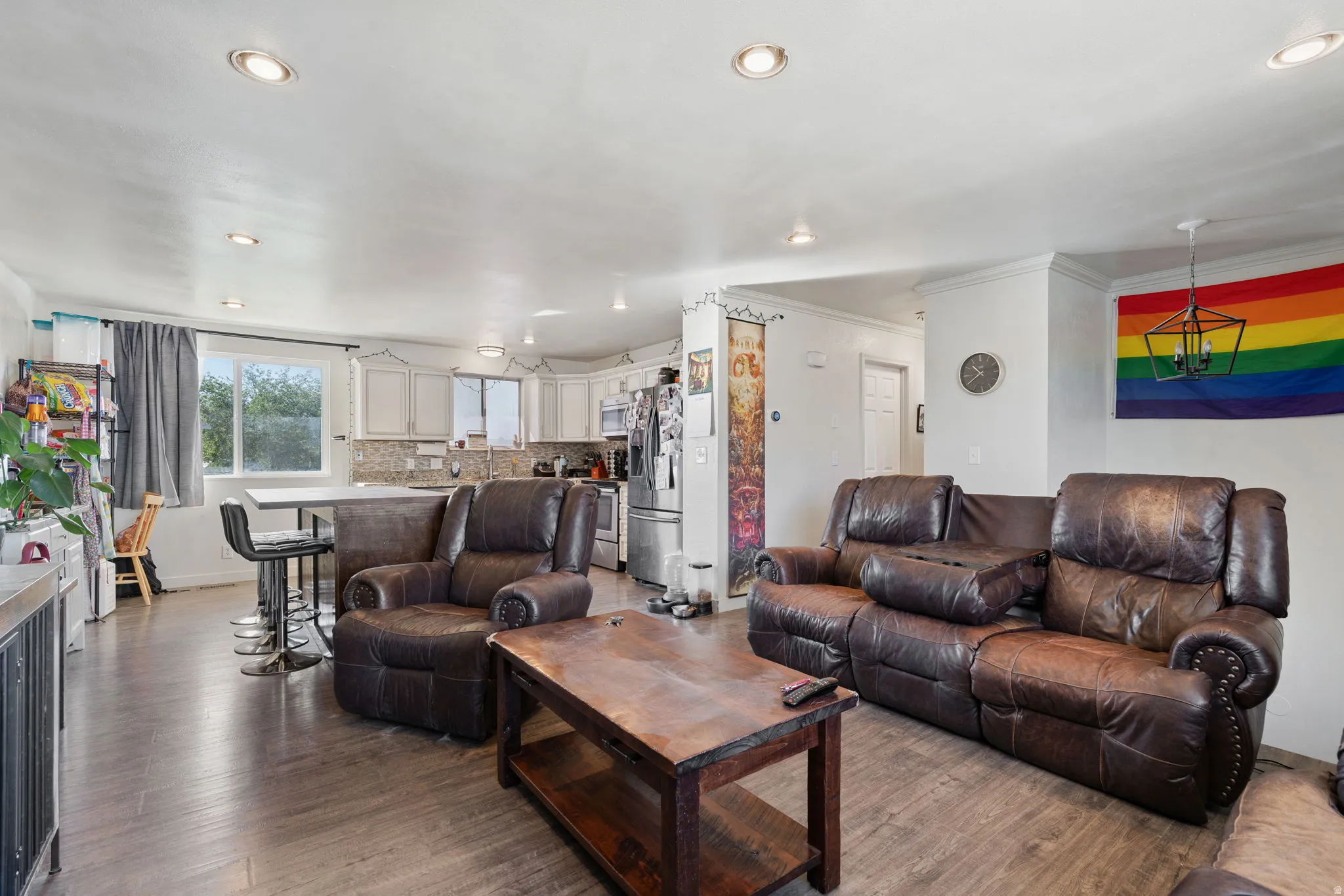 Open-concept living space featuring wood-finish flooring and recessed lighting