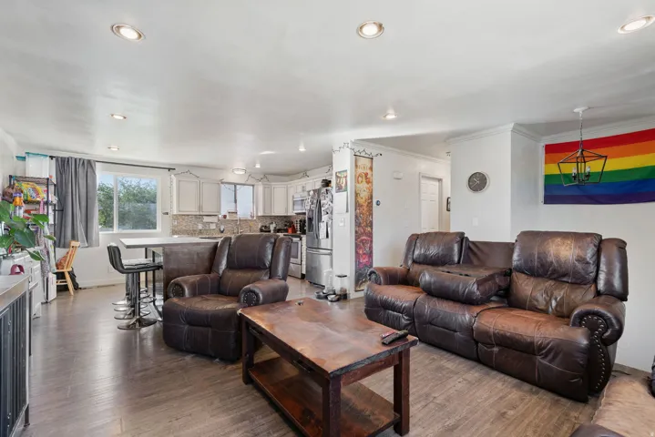 Open-concept living space featuring wood-finish flooring and recessed lighting