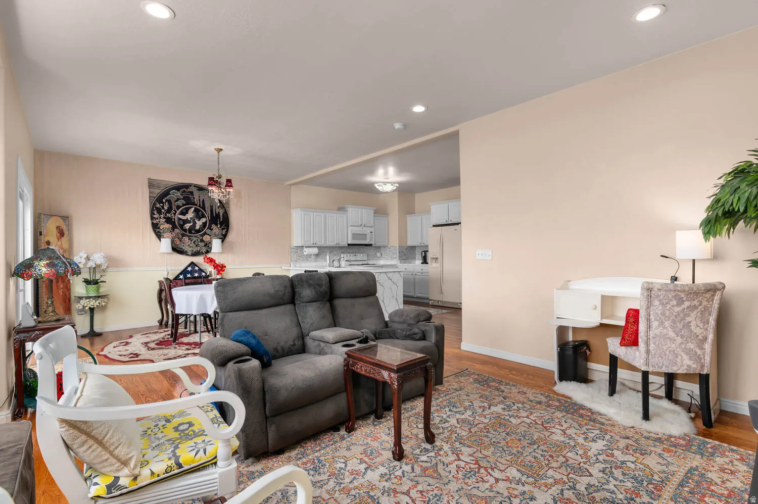 Open-concept living area featuring recessed lighting, hardwood flooring, and light-toned walls