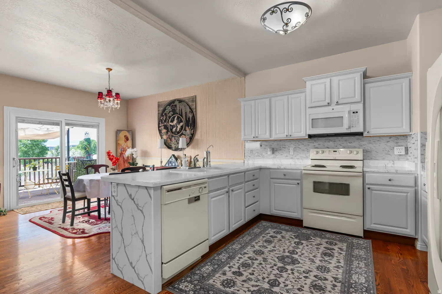 Kitchen featuring light grey cabinetry, white countertops, and a white tile backsplash