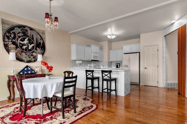 Open-concept kitchen and dining area featuring wood-finish flooring