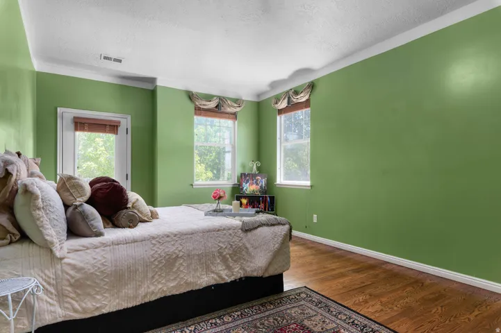 Wood-finish flooring throughout, complemented by white crown molding and baseboards