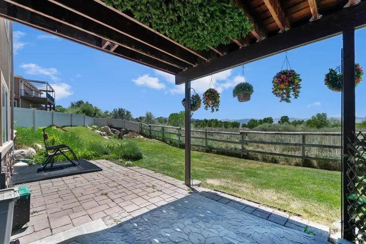 Covered patio featuring paver stones and wood beam construction
