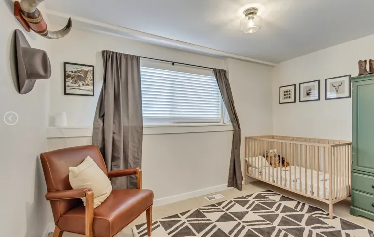 Neutral wall paint, a window with horizontal blinds, and a flush mount ceiling light fixture