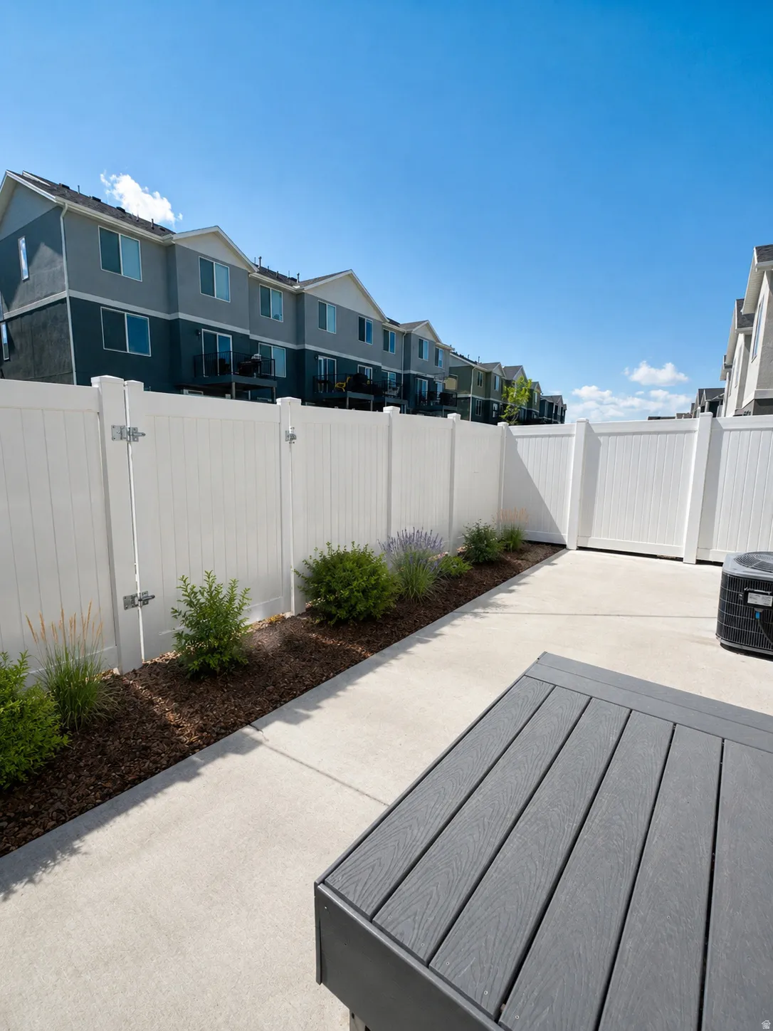 Private patio space featuring a concrete pad and gate to community green space