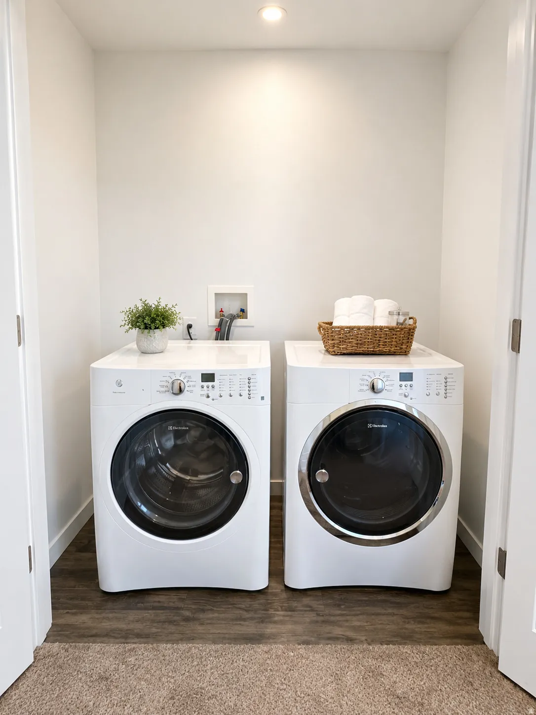 Dedicated laundry area featuring wood-finish flooring