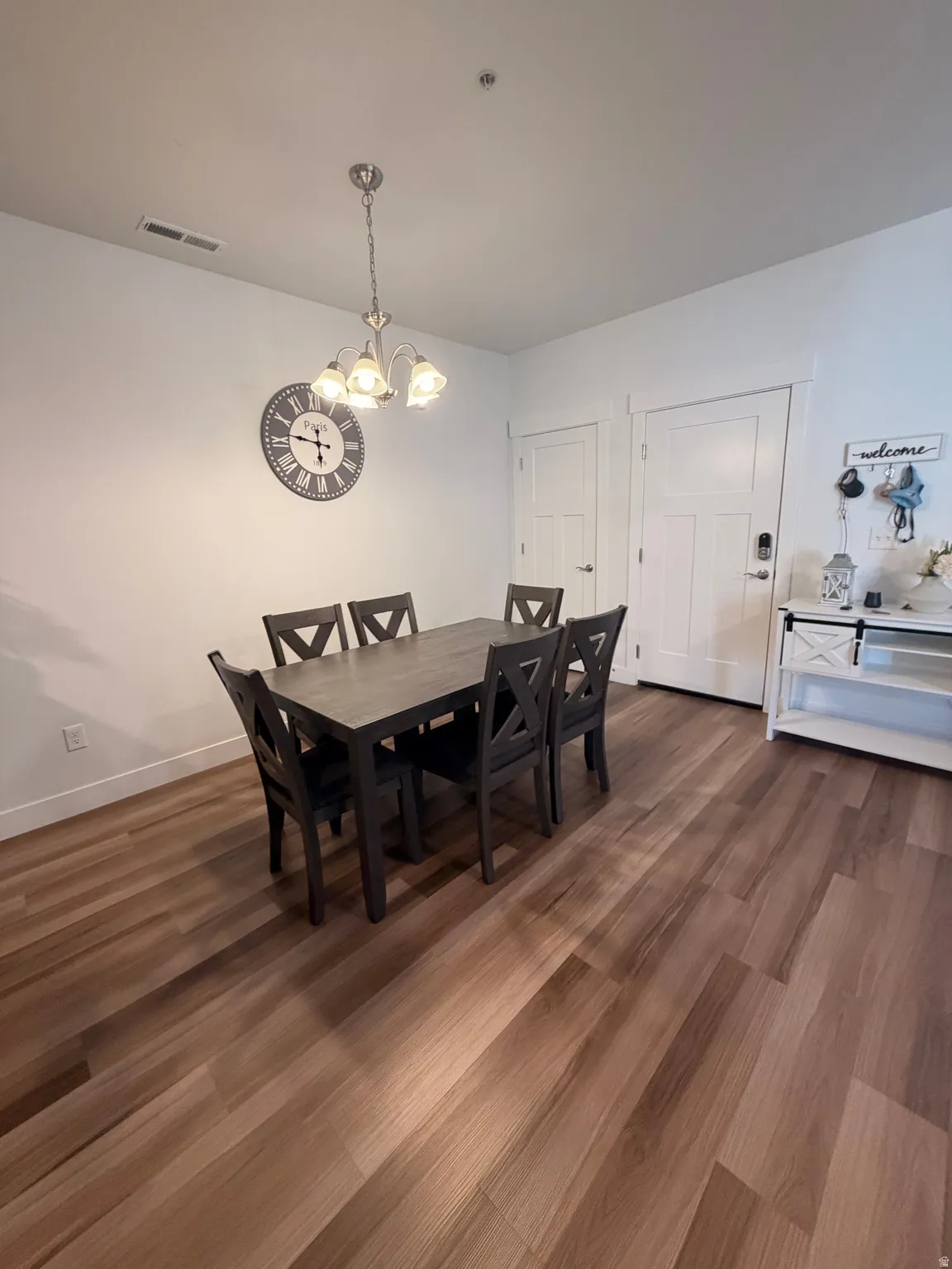 Wood-finish flooring throughout, complemented by white baseboards and walls