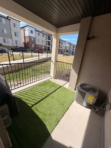 Covered patio featuring concrete flooring and a dark slatted ceiling