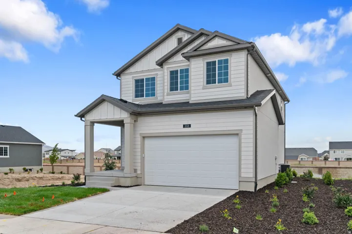 Modern two-story residence with a covered front porch and an attached two-car garage