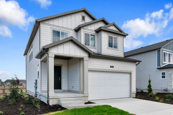 Contemporary two-story residence featuring light-colored horizontal siding and vertical board and batten accents
