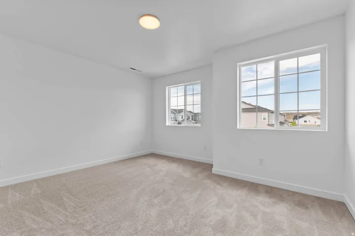 Bright room featuring two large windows with grid patterns