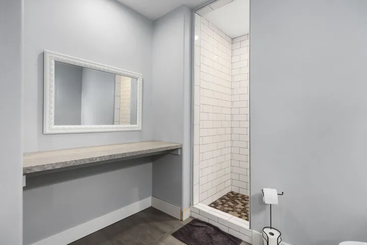 Floating vanity countertop with an ornate framed mirror