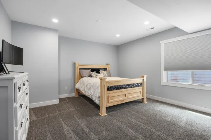 Bedroom featuring neutral gray walls and plush gray carpeting