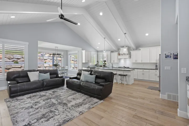 Vaulted planked ceilings with exposed beams and recessed lighting