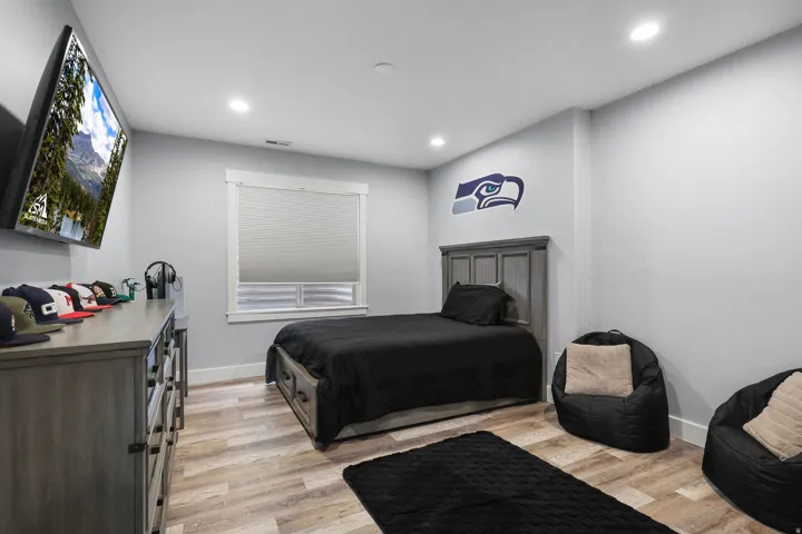 Room featuring wood-finish flooring, recessed lighting, and a window with blinds