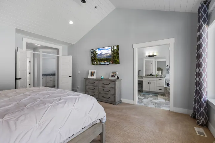 Vaulted ceiling with shiplap detail, recessed lighting, and a neutral carpeted floor