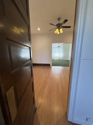 Entryway featuring wood-finish flooring and a decorative ceiling fan