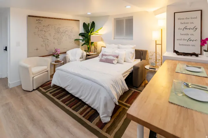 Light wood-finish flooring complements the white walls throughout this space