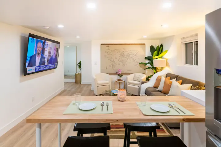 Open-concept living area featuring light wood-finish flooring, recessed lighting, and white baseboards