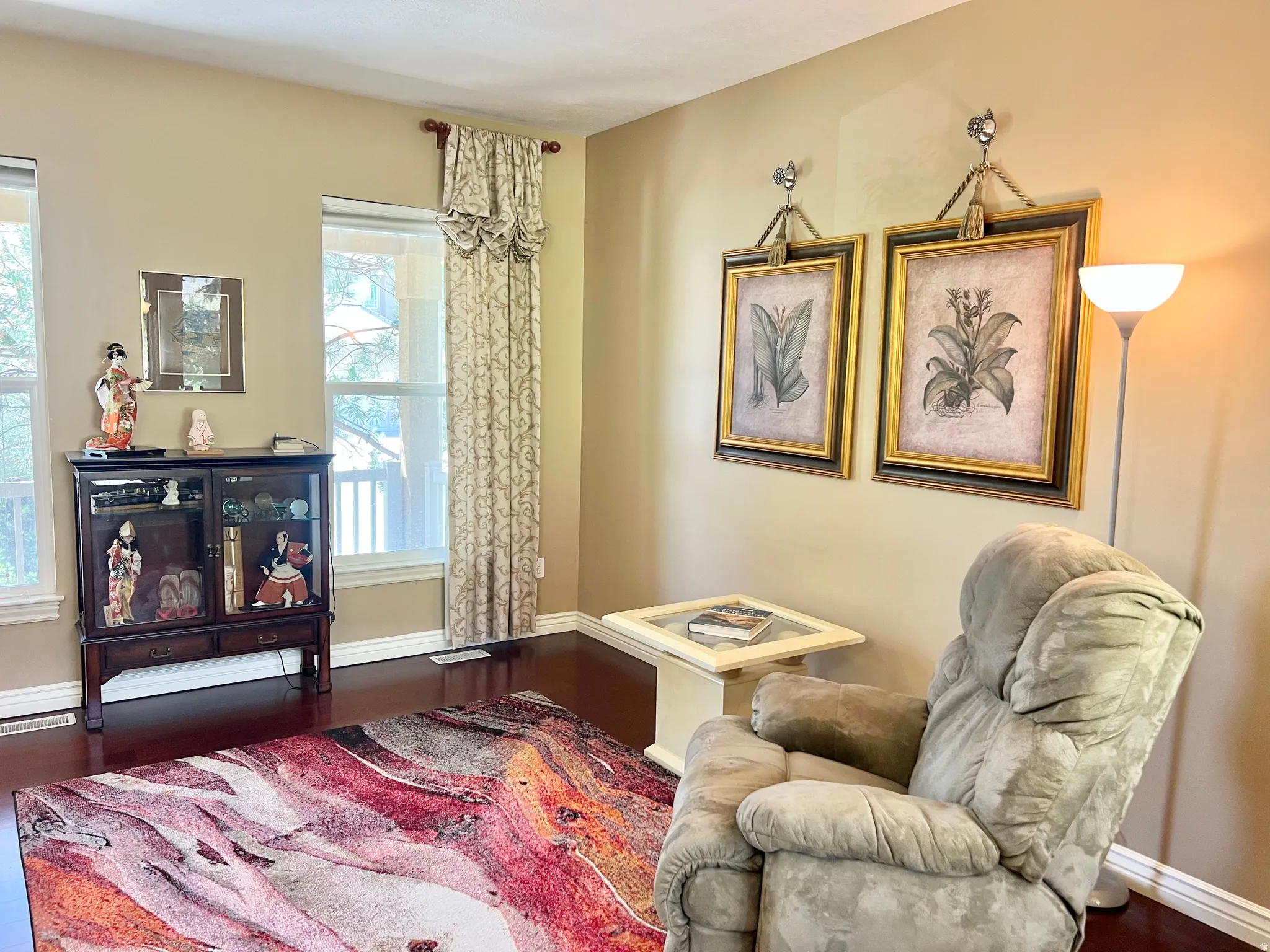 Room featuring rich wood-finish flooring and light-toned wall paint
