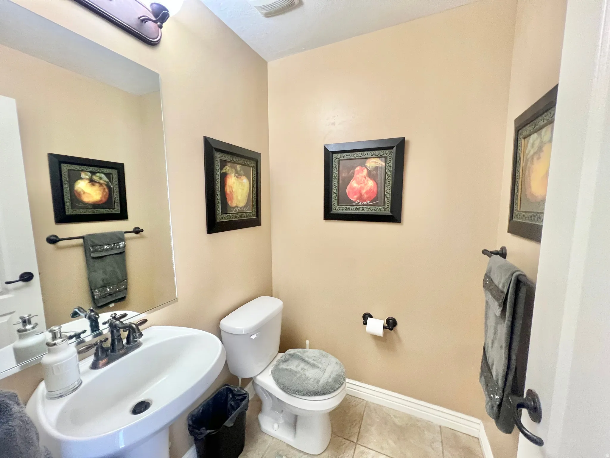 Pedestal sink with a bronze-finish faucet