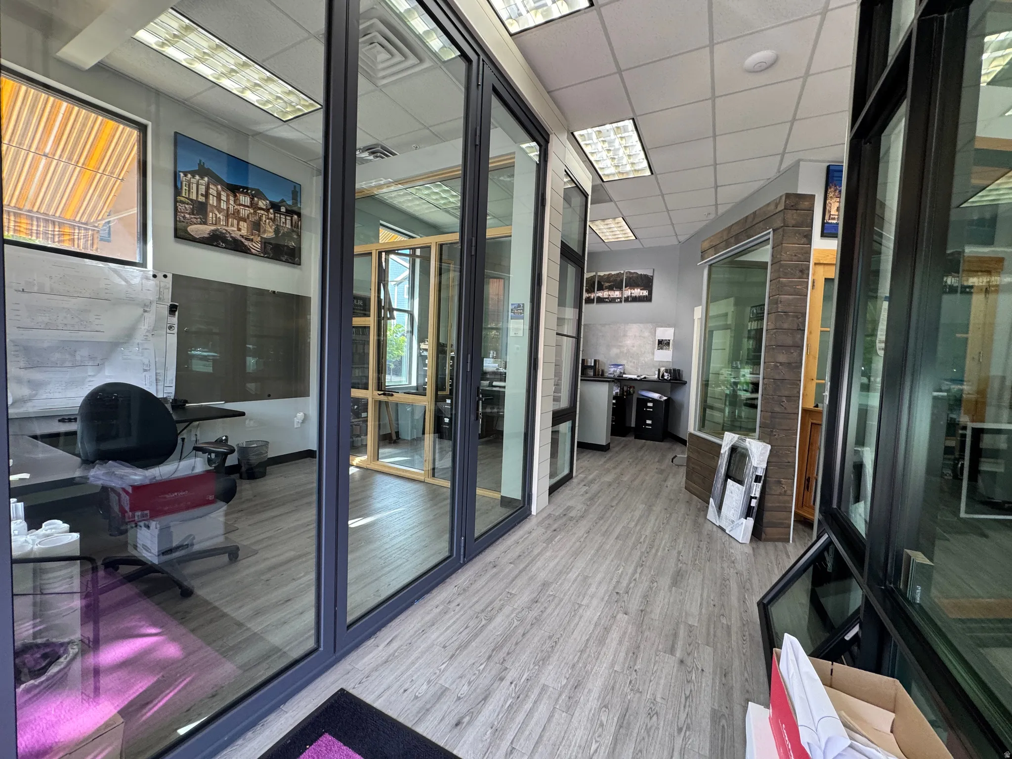 Commercial interior featuring wood-finish flooring and extensive glass partitions