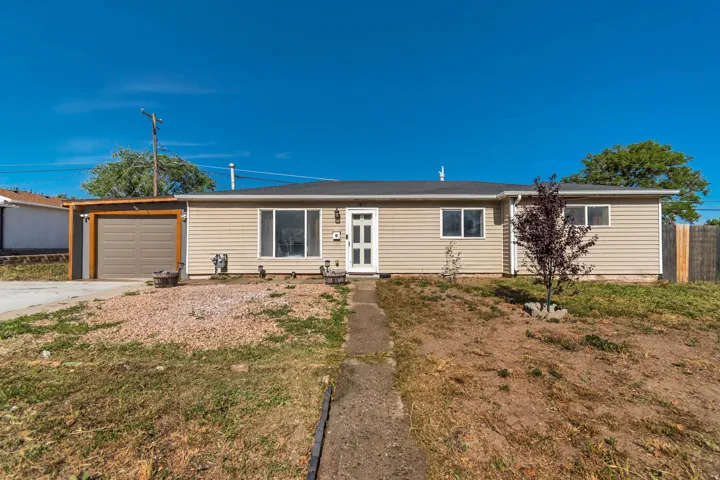 Ranch-style exterior with tan horizontal siding