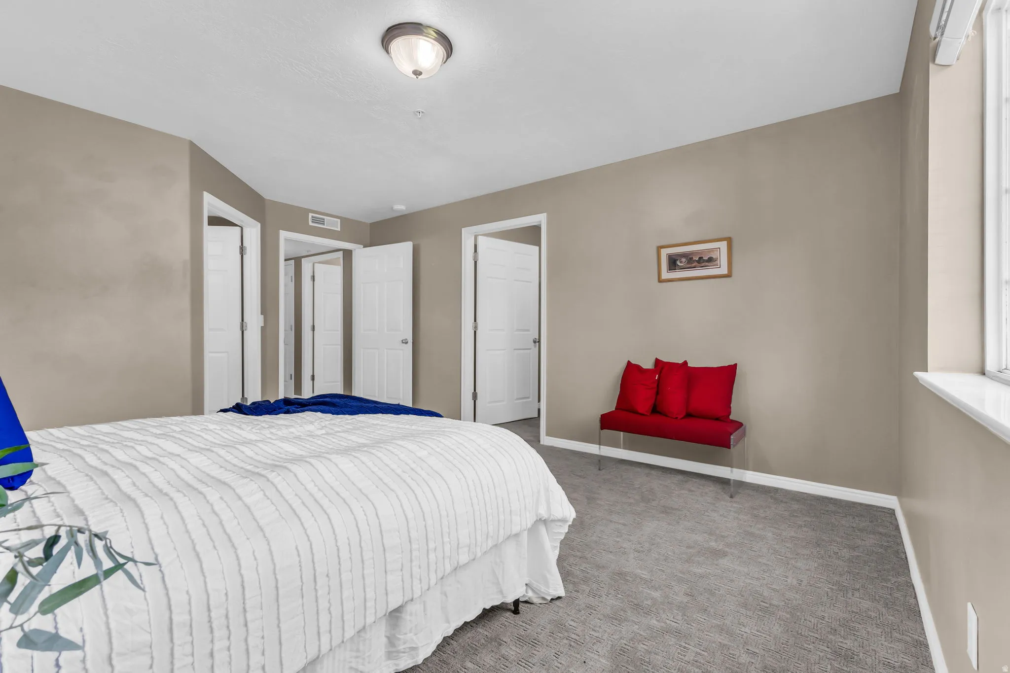 Neutral-toned walls complement the gray carpeting