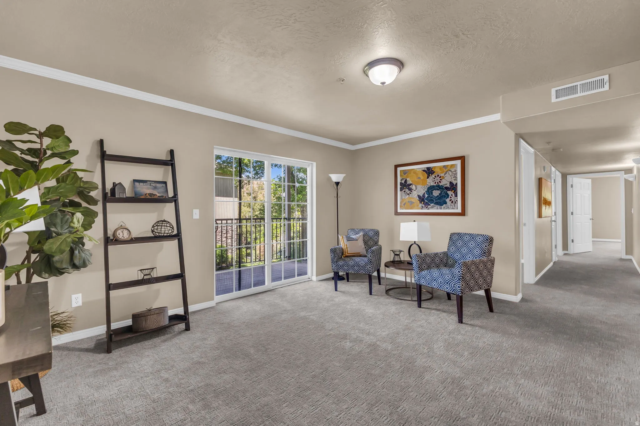 Living area featuring a sliding glass door with balcony access